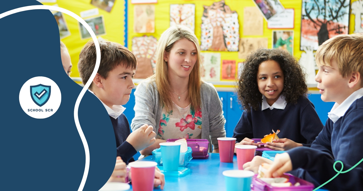 A female teacher sat down with multiple children around her.